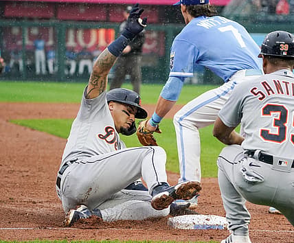Sep 10, 2022; Kansas City, Missouri, USA; Detroit Tigers shortstop Javier Baez (28) slides into third base safely as Kansas City Royals third baseman Bobby Witt Jr. (7) waits for the throw after hitting a one-run triple in the fifth inning at Kauffman Stadium. Mandatory Credit: Denny Medley-USA TODAY Sports