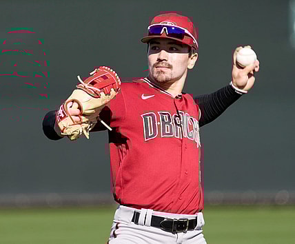 Feb 21, 2022; Scottsdale, Ariz., U.S.;  Diamondbacks minor league outfielder Corbin Carroll throws during a select training camp for minor-league players not covered by the Players Association at Salt River Fields. MLB continues to be in a lockout after the expiration of the collective bargaining agreement Dec. 2. Mandatory Credit: Michael Chow-Arizona Republic

Baseball Diamondbacks Select Minor League Camp