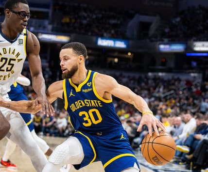 Feb 8, 2024; Indianapolis, Indiana, USA; Golden State Warriors guard Stephen Curry (30) dribbles the ball while Indiana Pacers forward Jalen Smith (25) defends in the first half at Gainbridge Fieldhouse. Mandatory Credit: Trevor Ruszkowski-USA TODAY Sports