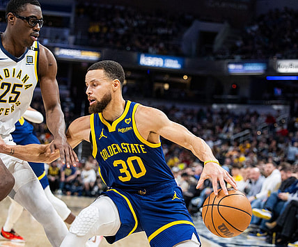 Feb 8, 2024; Indianapolis, Indiana, USA; Golden State Warriors guard Stephen Curry (30) dribbles the ball while Indiana Pacers forward Jalen Smith (25) defends in the first half at Gainbridge Fieldhouse. Mandatory Credit: Trevor Ruszkowski-USA TODAY Sports