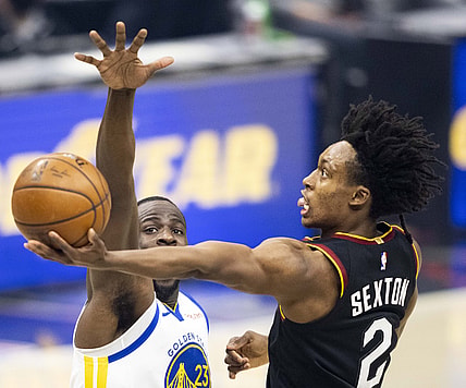 Apr 15, 2021; Cleveland, Ohio, USA; Cleveland Cavaliers guard Collin Sexton (2) lays the ball up past Golden State Warriors forward Draymond Green (23) during the first quarter at Rocket Mortgage FieldHouse. Mandatory Credit: Scott Galvin-USA TODAY Sports