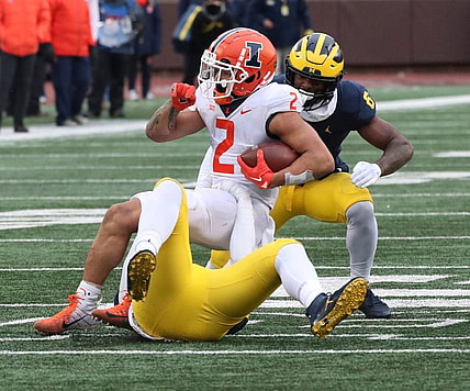 Michigan Wolverines defensive back Rod Moore (bottom) tackles Illinois Fighting Illini running back Chase Brown (2) during the second half Nov. 19, 2022 at Michigan Stadium.

Michill 111922 Kd 3896
