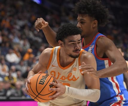 Mar 9, 2023; Nashville, TN, USA;  Mississippi Rebels forward Jaemyn Brakefield (4) guards Tennessee Volunteers forward Olivier Nkamhoua (13) during the second half at Bridgestone Arena. Mandatory Credit: Steve Roberts-USA TODAY Sports