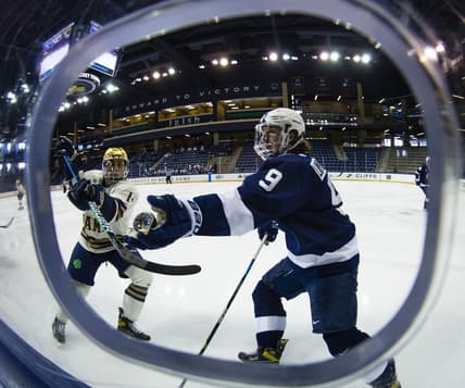 Mar 14, 2021; South Bend, Indiana, USA; Penn State's Alex Limoges (9) reaches out to grab a puck as Notre Dame s Jesse Lansdell (14) defends at the Compton Family Ice Arena. Mandatory Credit: Michael Caterina/South Bend Tribune-USA TODAY NETWORK