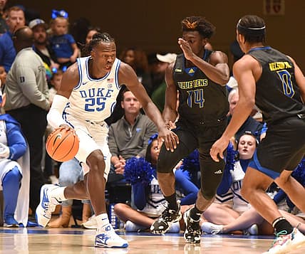 Nov 18, 2022; Durham, North Carolina, USA; Duke Blue Devils forward Mark Mitchell (25) dribbles the ball as Delaware Blue Hens guard Ebby Asamoah (14) defends during the first half at Cameron Indoor Stadium. Mandatory Credit: Rob Kinnan-USA TODAY Sports
