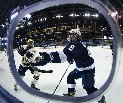 Mar 14, 2021; South Bend, Indiana, USA; Penn State's Alex Limoges (9) reaches out to grab a puck as Notre Dame s Jesse Lansdell (14) defends at the Compton Family Ice Arena. Mandatory Credit: Michael Caterina/South Bend Tribune-USA TODAY NETWORK