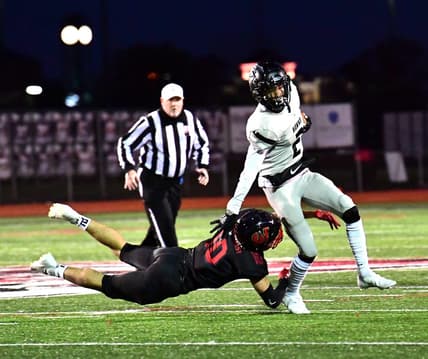 Lakota East's Caleb VanHooser (2) is tripped up by Silas Walters (10) of Lakota West in second-round OHSAA Division I playoff action, Oct. 16. 2020.

Ew 115