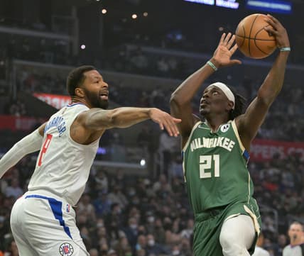 Feb 6, 2022; Los Angeles, California, USA;  Milwaukee Bucks guard Jrue Holiday (21) is defended by Los Angeles Clippers forward Marcus Morris Sr. (8) as he drives to the basket in the first half of the game at Crypto.com Arena. Mandatory Credit: Jayne Kamin-Oncea-USA TODAY Sports