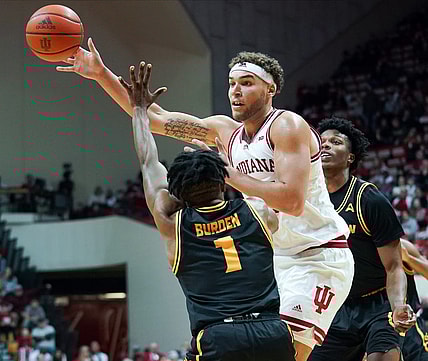 Dec 23, 2022; Bloomington, Indiana, USA;  Indiana Hoosiers forward Race Thompson (25) passes the ball around Kennesaw State Owls guard Terrell Burden (1) during the first half at Simon Skjodt Assembly Hall. Mandatory Credit: Robert Goddin-USA TODAY Sports