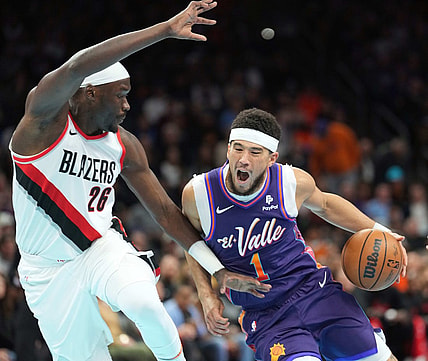 Nov 21, 2023; Phoenix, Arizona, USA; Phoenix Suns guard Devin Booker (1) dribbles against Portland Trail Blazers center Duop Reath (26) during the first half at Footprint Center. Mandatory Credit: Joe Camporeale-USA TODAY Sports