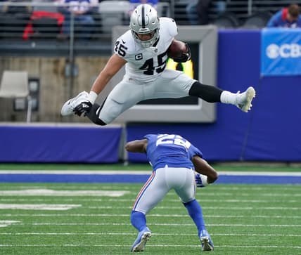 Nov 7, 2021; East Rutherford, N.J., USA;  Las Vegas Raiders fullback Alec Ingold (45) hurdles over New York Giants cornerback Adoree' Jackson (22) for yards in the second quarter at MetLife Stadium. Mandatory Credit: Robert Deutsch-USA TODAY Sports