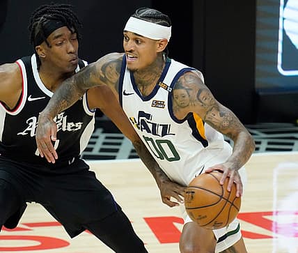 Jun 18, 2021; Los Angeles, California, USA; Utah Jazz guard Jordan Clarkson (00) dribbles the ball past LA Clippers guard Terance Mann (14) in the second quarter during game six in the second round of the 2021 NBA Playoffs at Staples Center. Mandatory Credit: Robert Hanashiro-USA TODAY Sports