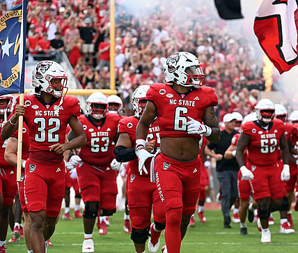 Sep 9, 2023; Raleigh, North Carolina, USA; North Carolina State Wolfpack players take the field prior to a game against the Notre Dame Fighting Irish at Carter-Finley Stadium. Mandatory Credit: Rob Kinnan-USA TODAY Sports