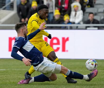 Vancouver Whitecaps defender Tristan Blackmon (6) slides in on Columbus Crew midfielder Derrick Etienne (22) during the second half of Saturday's season opener at Lower.com field in Columbus, Oh., on February 26, 2022.

Ceb Crew 0227 Bjp 30