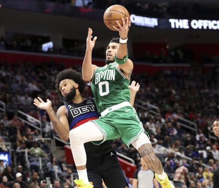 Nov 12, 2022; Detroit, Michigan, USA; Boston Celtics forward Jayson Tatum (0) scores against Detroit Pistons forward Marvin Bagley III (35) during the third period at Little Caesars Arena. Mandatory Credit: Kirthmon F. Dozier-USA TODAY Sports