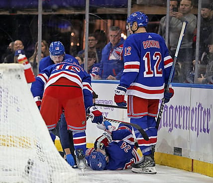Nov 27, 2023; New York, New York, USA; New York Rangers right wing Kaapo Kakko (24) is helped by a trainer on the ice after an injury to his left leg during the second period against the Buffalo Sabres at Madison Square Garden. Mandatory Credit: Danny Wild-USA TODAY Sports