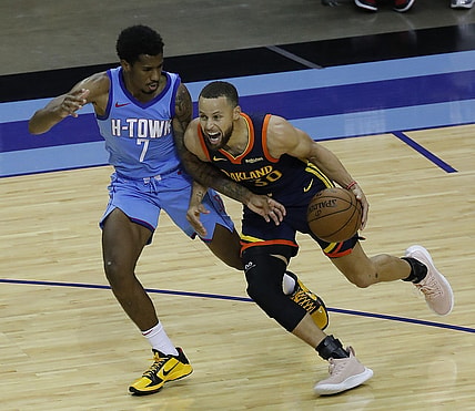 May 1, 2021; Houston, Texas, USA; Golden State Warriors guard Stephen Curry (30) drives against Houston Rockets guard Armoni Brooks (7) during the second quarter at Toyota Center. Mandatory Credit:  Bob Levey /POOL PHOTOS-USA TODAY Sports