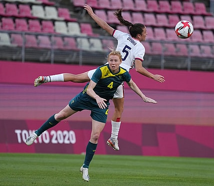 Jul 27, 2021; Ibaraki, Japan; Australia player Clare Polkinghorne (4) and USA player Kelley O'Hara (5) go for a header during the Tokyo 2020 Olympic Summer Games at Ibaraki Kashima Stadium. Mandatory Credit: Jack Gruber-USA TODAY Sports