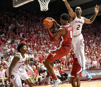 Mar 1, 2023; Tuscaloosa, AL, USA;  Alabama guard Jaden Bradley (0) looks to pass as Auburn forward Jaylin Williams (2) leaps toward him at Coleman Coliseum. Alabama defeated Auburn 90-85 in overtime to claim the regular season SEC Championship.

Ncaa Basketball Auburn Tigers At Alabama Crimson Tide