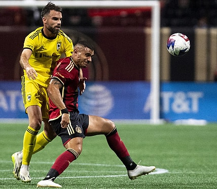 Oct 7, 2023; Atlanta, Georgia, USA;  Columbus Crew defender Rudy Camacho (4) holds back Atlanta United forward Giorgos Giakoumakis (7) at Mercedes-Benz Stadium. Mandatory Credit: Julie Bennett-USA TODAY Sports