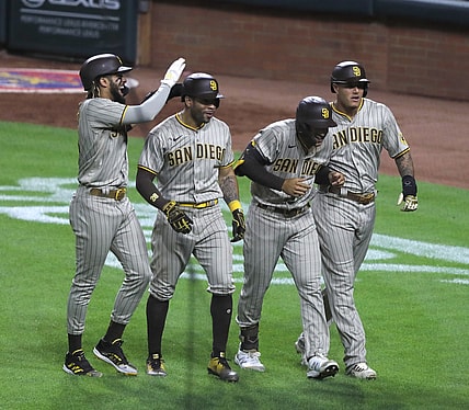 Jun 30, 2021; Cincinnati, Ohio, USA; San Diego Padres center fielder Trent Grisham (second from right) celebrates with shortstop Fernando Tatis Jr. (left) left fielder Tommy Pham (28) and third baseman Manny Machado (right) after hitting a grand slam against the Cincinnati Reds during the fifth inning at Great American Ball Park. Mandatory Credit: David Kohl-USA TODAY Sports