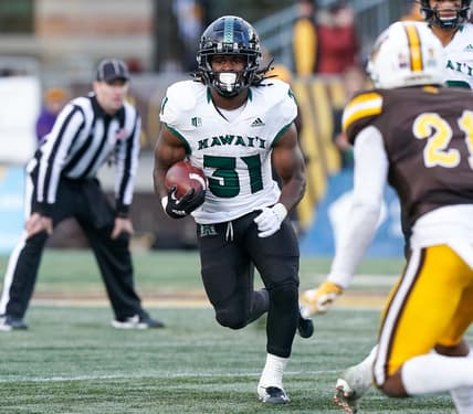 Nov 27, 2021; Laramie, Wyoming, USA; Hawaii Rainbow Warriors running back Dedrick Parson (31) runs against the Wyoming Cowboys during the fourth quarter at Jonah Field at War Memorial Stadium. Mandatory Credit: Troy Babbitt-USA TODAY Sports