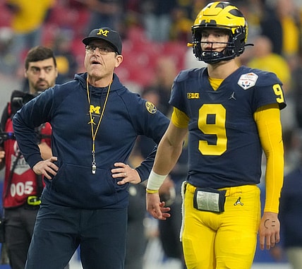 Dec 31, 2022; Glendale, Arizona, USA; Michigan Wolverines head coach Jim Harbaugh watches as J.J. McCarthy (9) warms up before they take on the TCU Horned Frogs in the Vrbo Fiesta Bowl at State Farm Stadium. Mandatory Credit: Joe Rondone-Arizona Republic

Ncaa Fiesta Bowl Game