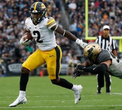 Iowa Hawkeyes running back Kaleb Johnson (2) stiff arms Purdue Boilermakers linebacker Semisi Fakasiieiki (97) during the NCAA football game, Saturday, Nov. 5, 2022, at Ross-Ade Stadium in West Lafayette, Ind.

Purdueiowafb110522 Am30607