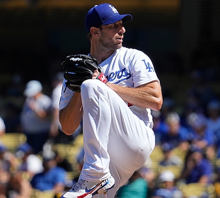 Sep 12, 2021; Los Angeles, California, USA; Los Angeles Dodgers starting pitcher Max Scherzer (31) winds up to throw a pitch in the fourth inning against the San Diego Padres at Dodger Stadium. Mandatory Credit: Robert Hanashiro-USA TODAY Sports