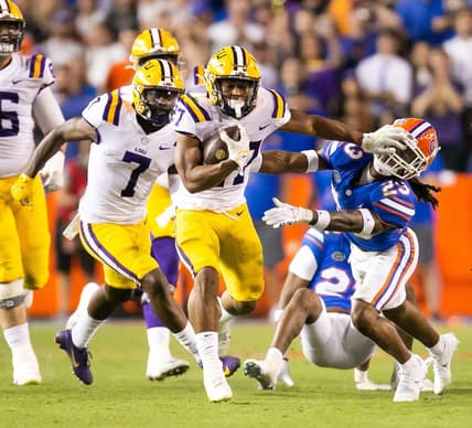 LSU Tigers running back Josh Williams (27) throws a stiff arm to Florida Gators cornerback Jaydon Hill (23) in the second half at Steve Spurrier Field at Ben Hill Griffin Stadium in Gainesville, FL on Saturday, October 15, 2022. LSU defeated the Gators 45-35. [Doug Engle/Gainesville Sun]

Ncaa Football Florida Gators Vs Lsu Tigers