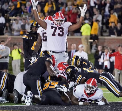 Oct 1, 2022; Columbia, Missouri, USA; Georgia Bulldogs running back Daijun Edwards (30) sores against the Missouri Tigers as offensive lineman Xavier Truss (73) celebrates during the first half at Faurot Field at Memorial Stadium. Mandatory Credit: Denny Medley-USA TODAY Sports