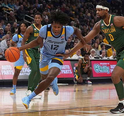 Marquette forward Olivier-Maxence Prosper (12) drives past Baylor forward Flo Thamba (0) during the first half of their game Tuesday, November 29, 2022 at Fiserv Forum in Milwaukee, Wis.

Mumen29 14