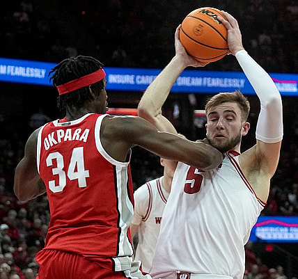Feb 13, 2024; Madison, Wisconsin, USA;. Ohio State center Felix Okpara (34) grads Wisconsin forward Tyler Wahl (5) during the second half of their game at the Kohl Center. Mandatory Credit: Mark Hoffman/Milwaukee Journal Sentinelf-USA TODAY Sports