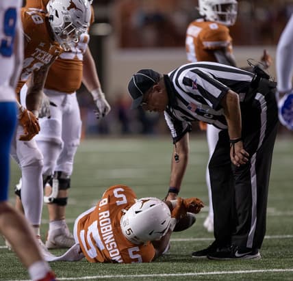 A referee checks on Texas running back Bijan Robinson (5) after an injury during the game against the Kansas Jayhawks on Saturday, Nov. 13, 2021.

Mlc Ut V Kansas 1594