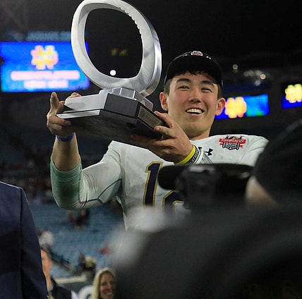Notre Dame Fighting Irish quarterback Tyler Buchner (12) is awarded with his MVP game trophy after Friday night's victory over the South Carolina Gamecocks. The University of Notre Dame Fighting Irish took on the University of South Carolina Gamecocks in the TaxSlayer Gator Bowl game in Jacksonville, Florida's TIAA Bank Field Friday, December 30, 2022.