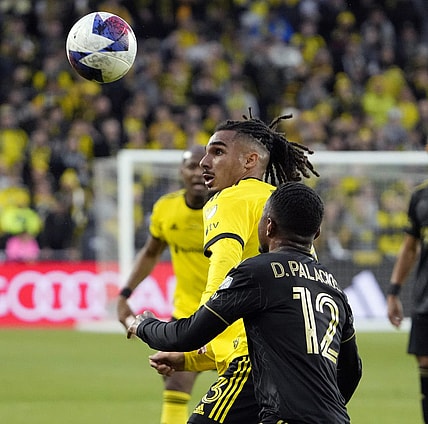 Dec 9, 2023; Columbus, OH, USA; Columbus Crew defender Mohamed Farsi (23) battles for the ball against Los Angeles FC defender Diego Palacios (12) in the first half during 2023 MLS CUP at Lower.com Field.