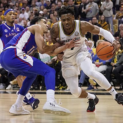 Dec 10, 2022; Columbia, Missouri, USA; Missouri Tigers guard DeAndre Gholston (4) dribbles the ball as Kansas Jayhawks guard Kevin McCullar Jr. (15) defends during the first half at Mizzou Arena. Mandatory Credit: Denny Medley-USA TODAY Sports