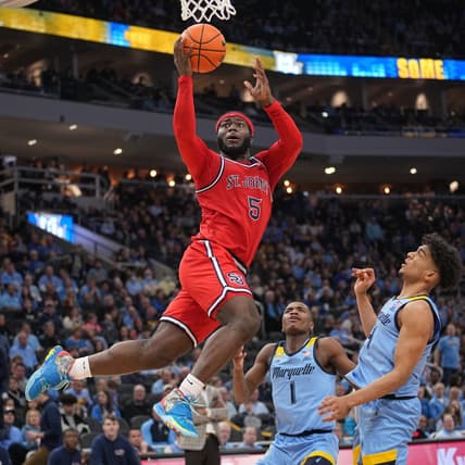 Mar 4, 2023; Milwaukee, Wisconsin, USA; St. John's Red Storm guard Dylan Addae-Wusu (5) scores on Marquette Golden Eagles guard Stevie Mitchell (4) during the second half of their game at Fiserv Forum. Marquette won the Big East Conference regular season championship. Mandatory Credit: Mark Hoffman-USA TODAY Sports