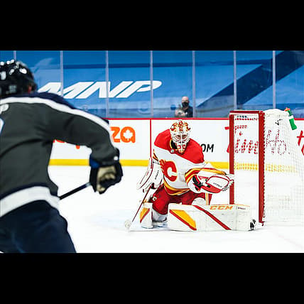 Feb 4, 2021; Winnipeg, Manitoba, CAN; Calgary Flames goalie Jacob Markstrom (25) makes a save on a shot by Winnipeg Jets forward Andrew Copp (9) during the second period at Bell MTS Place. Mandatory Credit: Terrence Lee-USA TODAY Sports