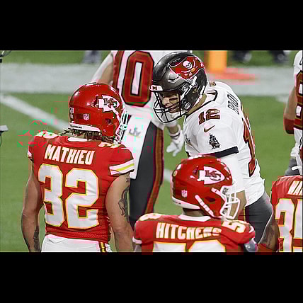 Feb 7, 2020; Tampa, FL, USA; Tampa Bay Buccaneers quarterback Tom Brady (12) talks with Kansas City Chiefs strong safety Tyrann Mathieu (32) during the second quarter of Super Bowl LV at Raymond James Stadium. Mandatory Credit: Kim Klement-USA TODAY Sports