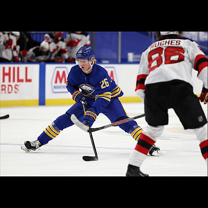 Jan 30, 2021; Buffalo, New York, USA; Buffalo Sabres defenseman Rasmus Dahlin (26) carries the puck up ice during the third period against the New Jersey Devils at KeyBank Center. Mandatory Credit: Timothy T. Ludwig-USA TODAY Sports