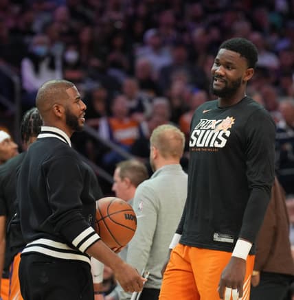 Mar 18, 2022; Phoenix, Arizona, USA; Phoenix Suns guard Chris Paul (left) and Phoenix Suns center Deandre Ayton talk during the second half of the game against the Phoenix Suns at Footprint Center. Mandatory Credit: Joe Camporeale-USA TODAY Sports