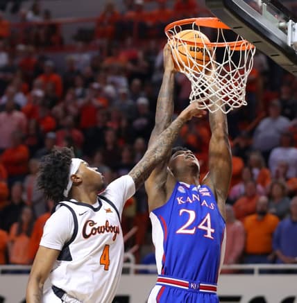 Kansas Jayhawks forward K.J. Adams Jr. (24) dunks the ball beside Oklahoma State Cowboys guard Woody Newton (4) during a men's college basketball game between the Oklahoma State University Cowboys and the Kansas Jayhawks at Gallagher-Iba Arena in Stillwater, Okla., Tuesday, Feb. 14, 2023.

Osu Vs Kansas Basketball