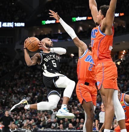 Nov 5, 2022; Milwaukee, Wisconsin, USA; Milwaukee Bucks guard Jevon Carter (5) drives to the basket against Oklahoma City Thunder guard Shai Gilgeous-Alexander (2) in the second quarter at Fiserv Forum. Mandatory Credit: Michael McLoone-USA TODAY Sports