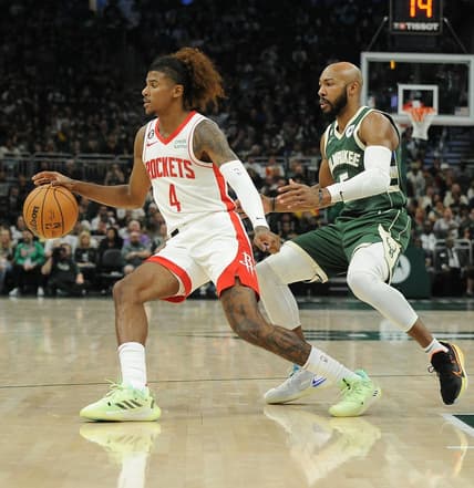 Oct 22, 2022; Milwaukee, Wisconsin, USA; Houston Rockets guard Jalen Green (4) brings the ball up the court against Milwaukee Bucks guard Jevon Carter (5) in the third quarter at Fiserv Forum. Mandatory Credit: Michael McLoone-USA TODAY Sports