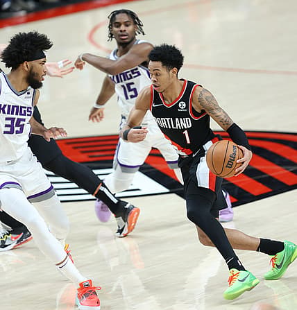 Jan 9, 2022; Portland, Oregon, USA;  Portland Trail Blazers guard Anfernee Simons (1) drives on Sacramento Kings forward Marvin Bagley III (35) in the second half at Moda Center. Mandatory Credit: Jaime Valdez-USA TODAY Sports