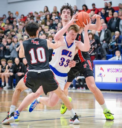 Wisconsin Lutheran guard Kon Knueppel (33) is fouled as he drives to the basket between Pewaukee guard Karson Osterman (10) and forward Milan Momcilovic (22) on Tuesday January 3, 2023, at Wisconsin Lutheran High School in Milwaukee, Wisconsin.

Pewaukee