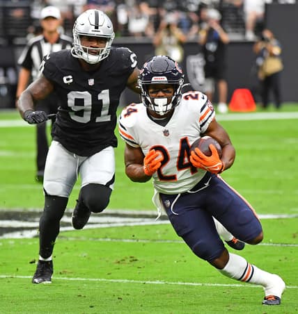 Oct 10, 2021; Paradise, Nevada, USA; Chicago Bears running back Khalil Herbert (24) rushes through a gap as Las Vegas Raiders defensive end Yannick Ngakoue (91) pursues the play at Allegiant Stadium. Mandatory Credit: Stephen R. Sylvanie-USA TODAY Sports
