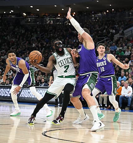 Mar 30, 2023; Milwaukee, Wisconsin, USA; Boston Celtics guard Jaylen Brown (7) drives to the basket against Milwaukee Bucks center Brook Lopez (11) at Fiserv Forum. Mandatory Credit: Michael McLoone-USA TODAY Sports