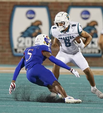 Sep 10, 2021; Conway, South Carolina, USA;  Coastal Carolina Chanticleers wide receiver Jaivon Heiligh (6) moves the ball against Kansas Jayhawks safety O.J. Burroughs (5) during action at Brooks Stadium. Mandatory Credit: David Yeazell-USA TODAY Sports